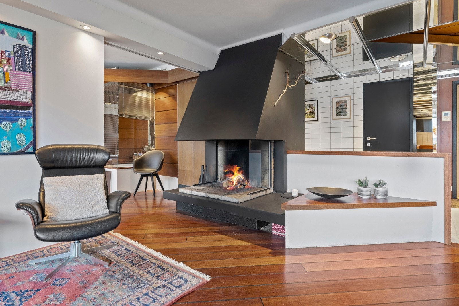 Sentralt i stuen er det plassert en åpen peis som gir godt med varme og hyggelige stunder på de kaldere dagene. Galleribilde