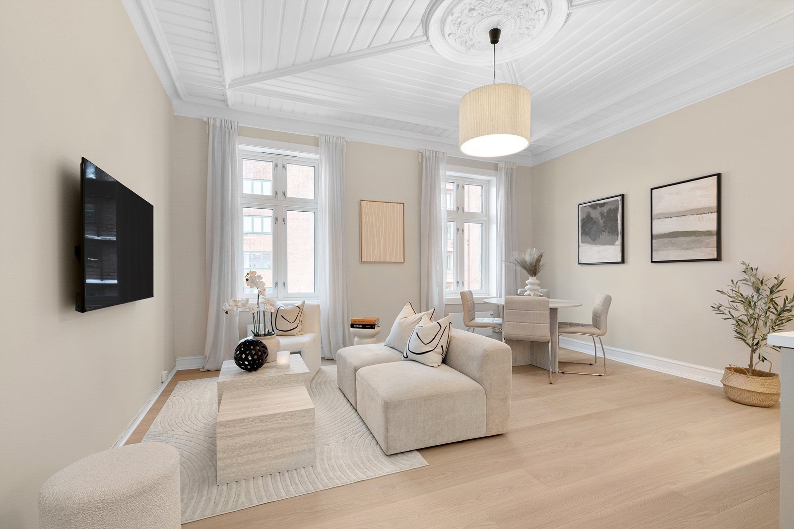 Leiligheten er preget av store vindusflater som skaper en lys og luftig atmosfære. Merk deg taket og den nydelige rosetten Galleribilde