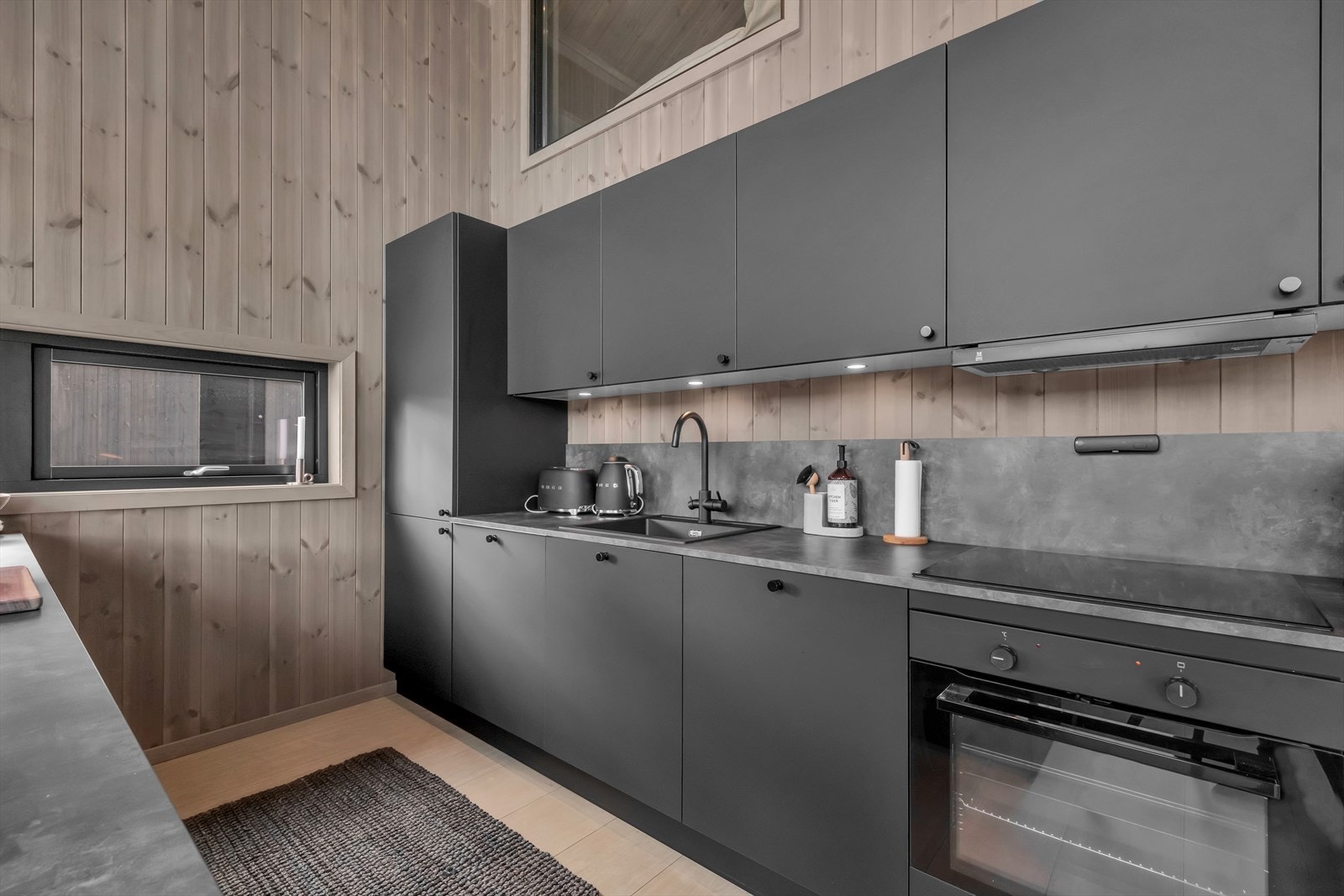 Kjøkkeninnredningen er utstyrt med integrerte hvitevarer for et sømløst og stilrent uttrykk. Galleribilde