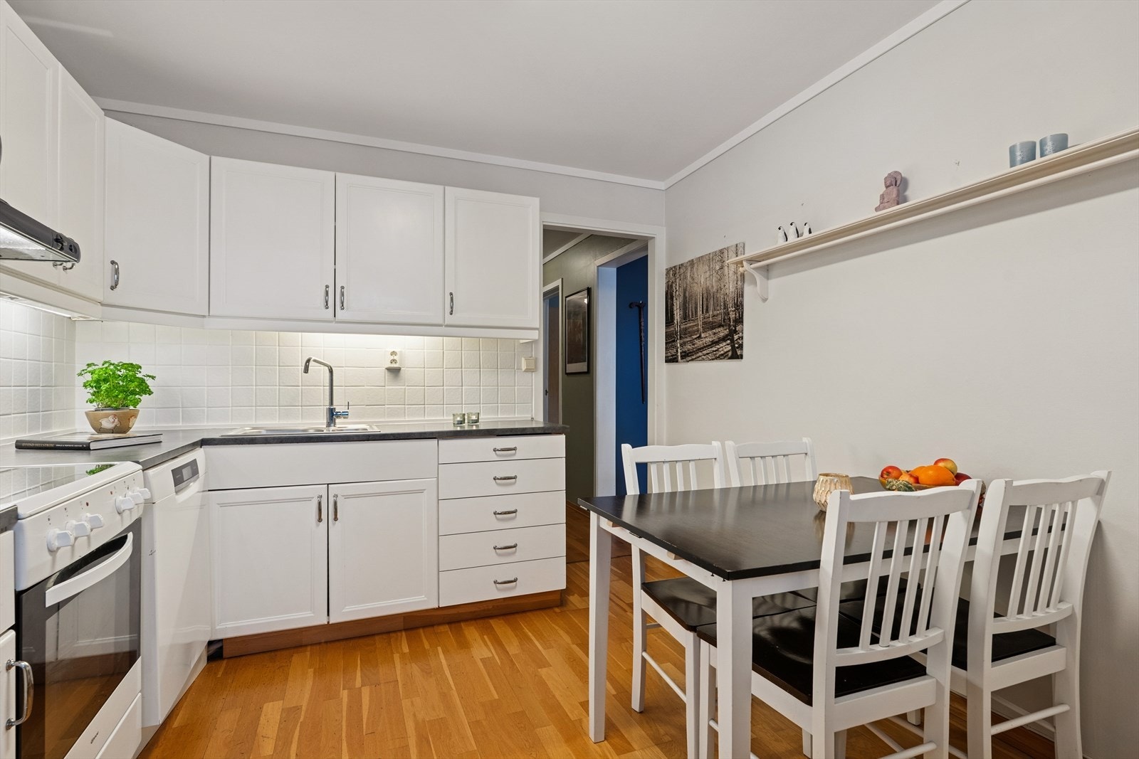 Kjøkkeninnredning med god lagringsplass og rommet har plass til spisebord og stoler for hverdagsmåltider. Galleribilde