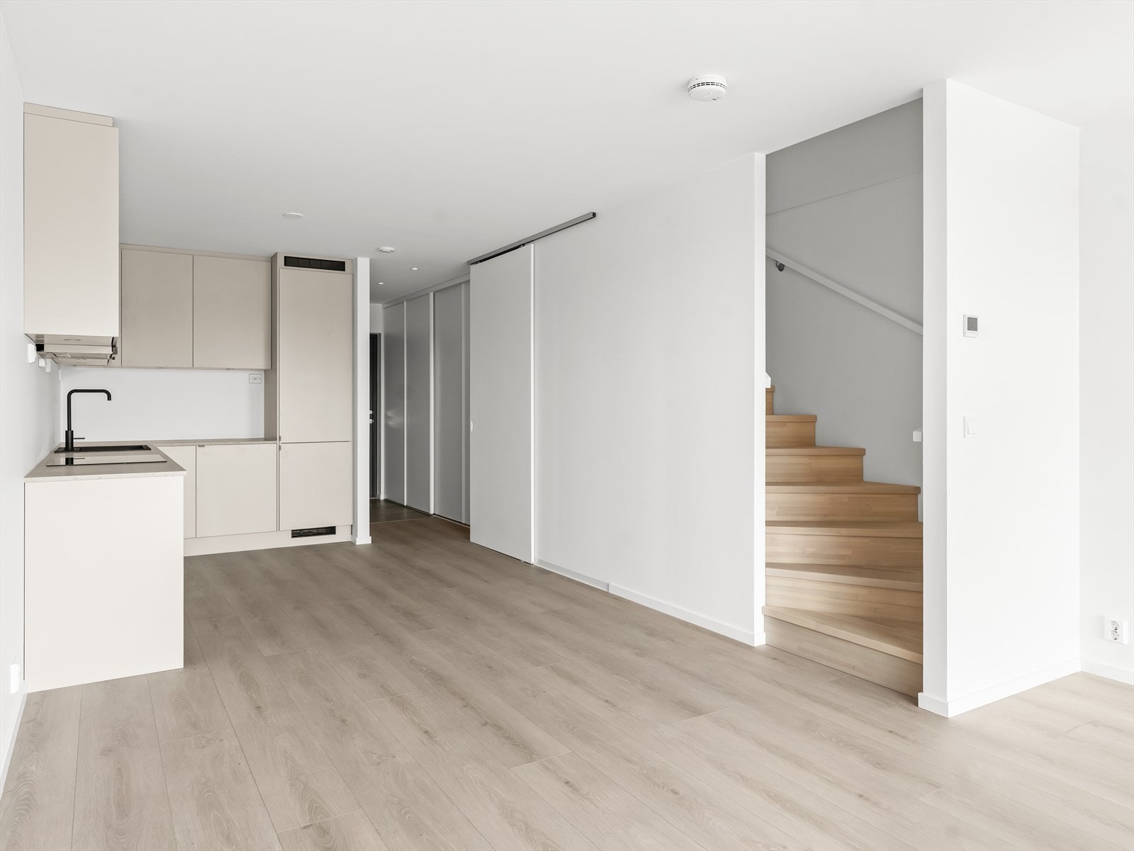 Stue og kjøkken ligger i åpen løsning og er et sosialt, luftig allrom med nydelige lysforhold. Galleribilde