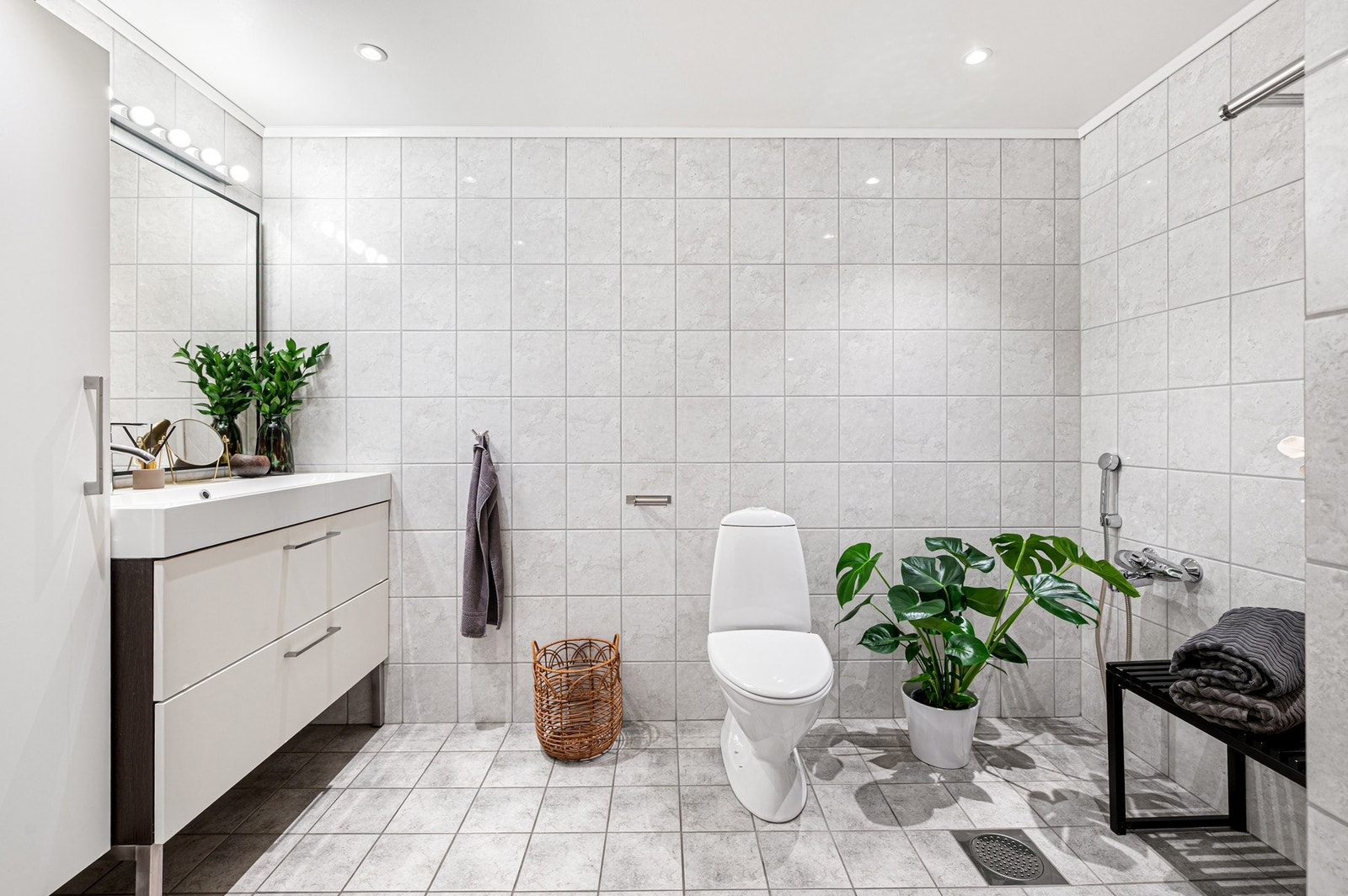 Hvitt flislagt bad på 8,1m² med downlights i himling. Galleribilde