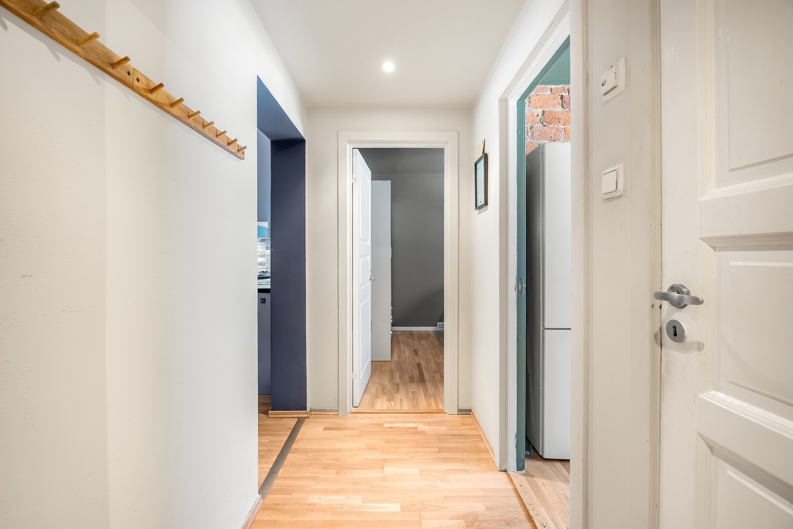 Entréen har lysmalte vegger, trestavs parkett og innfelt downlights. Galleribilde