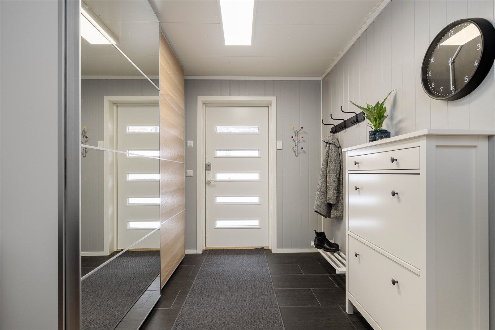 En innbydende og funksjonell entré med god plass til å henge fra seg yttertøy. Galleribilde