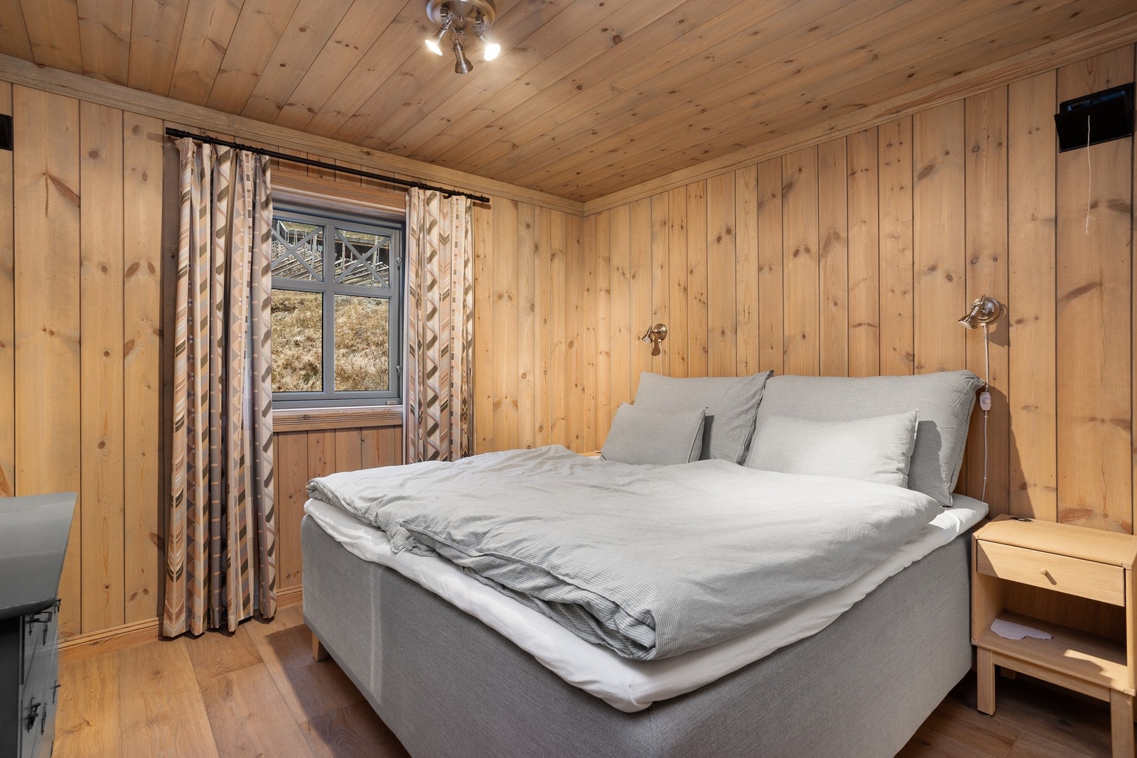 Hovedsoverom innredet med dobbeltseng og kommode Galleribilde