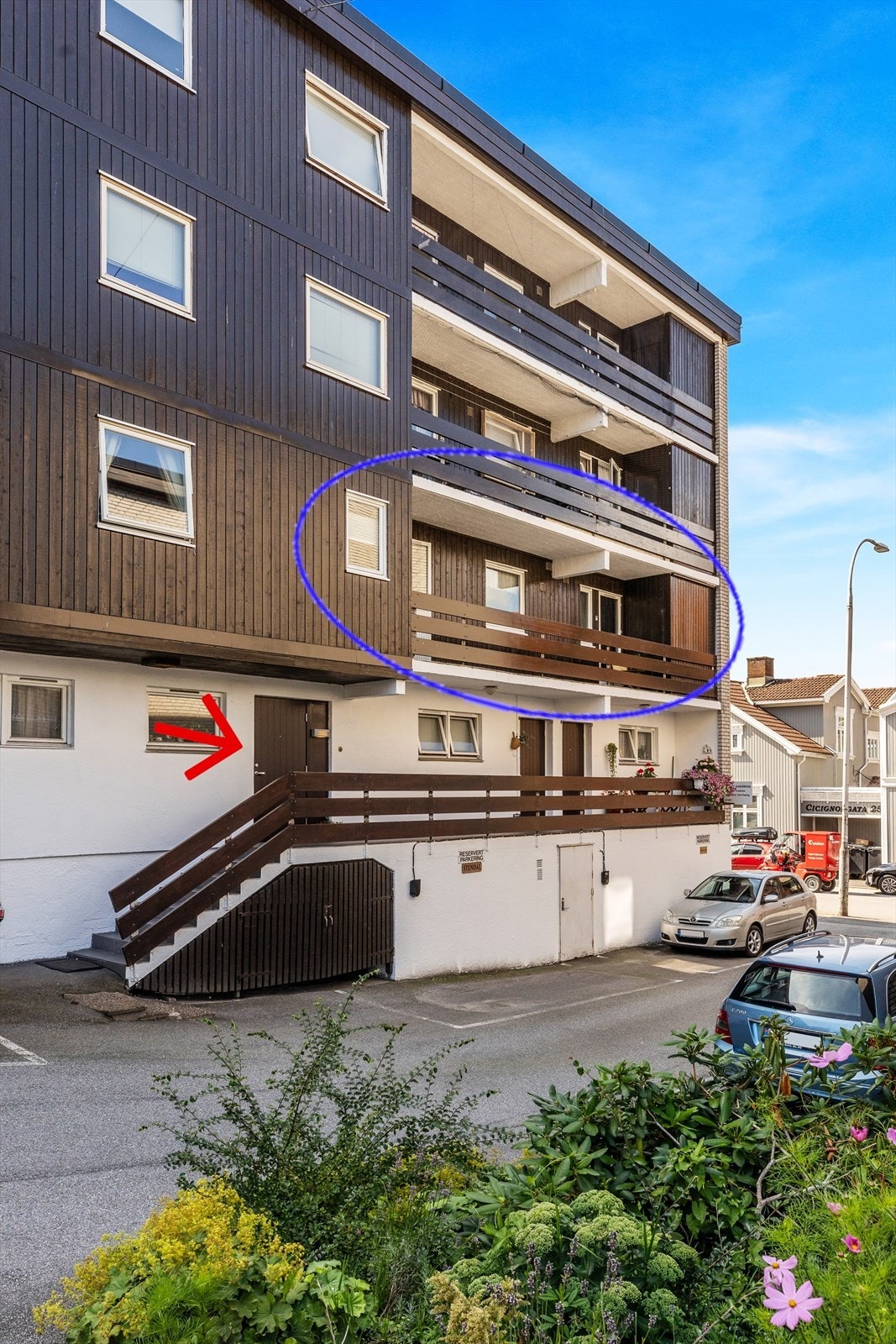 Inngangsdør til leiligheten ligger i bakgården. Første dør ved trappen. På bildet ser du også verandaen med bod i enden. Galleribilde