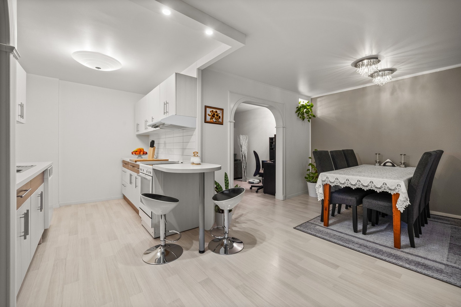 Leilighetens kjøkken ligger i en delvis åpen og sosial løsning med spisestuen Galleribilde