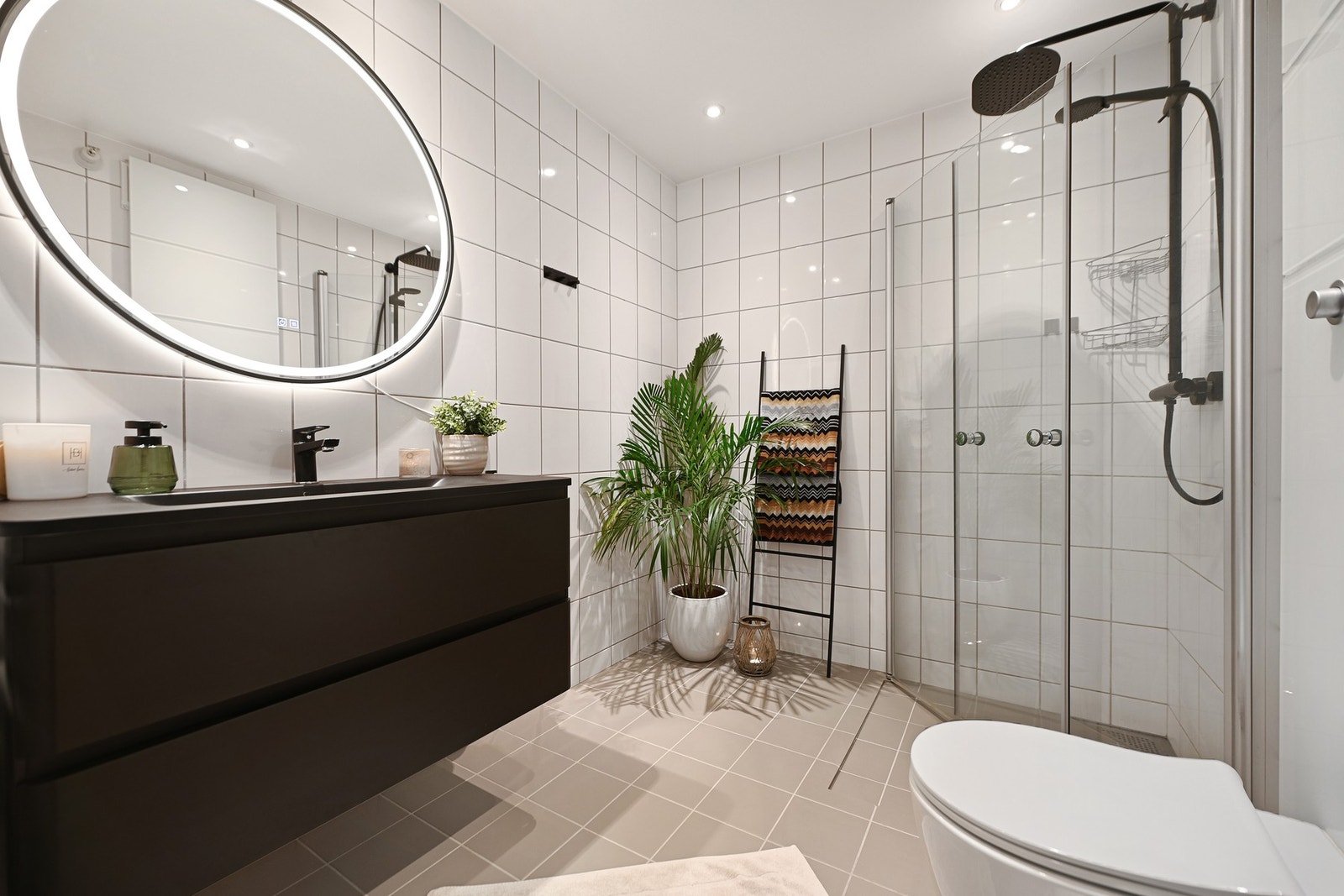 Leiligheten har et delikat bad. Innredningen er holdt i tidsriktige farger, gulvet er belagt med fliser og har gulvvarme som gir behagelig, barfotvennlig varme. Galleribilde