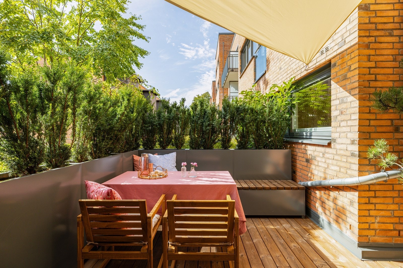 Beplantning i plantekasser rundt leiligheten er vintergrønne og skjermer derfor gjennom hele året. Galleribilde