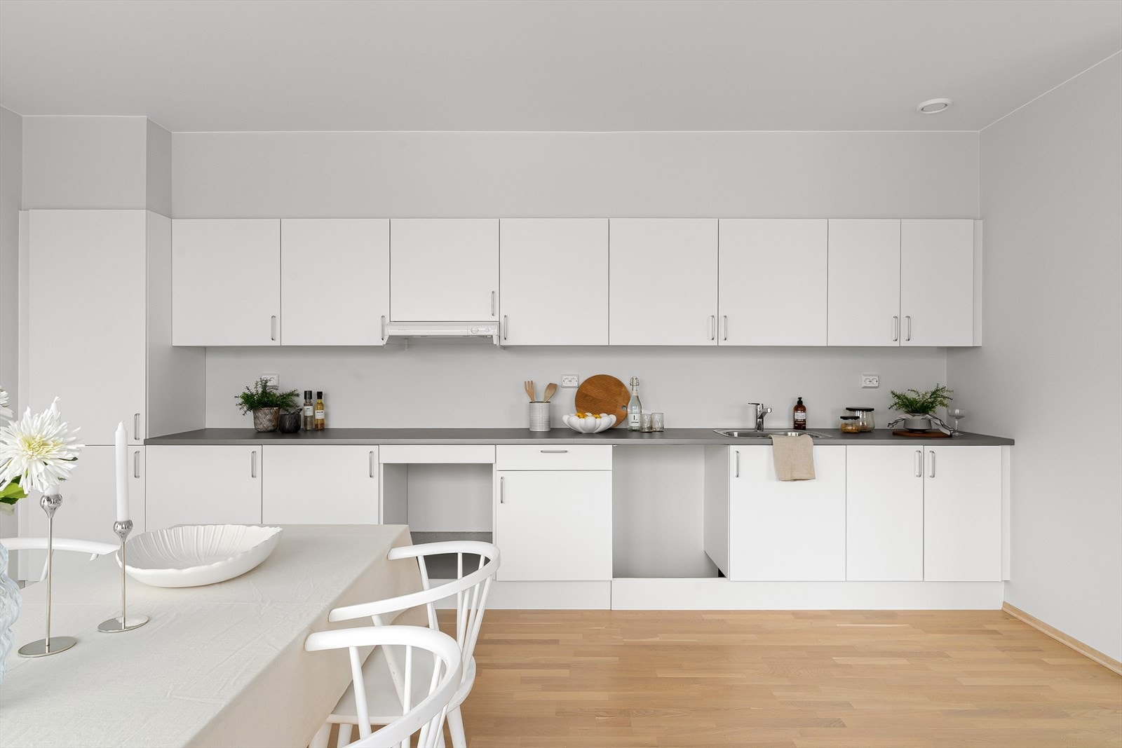 Kjøkken med pen kjøkkeninnredning i hvit utførelse. Galleribilde
