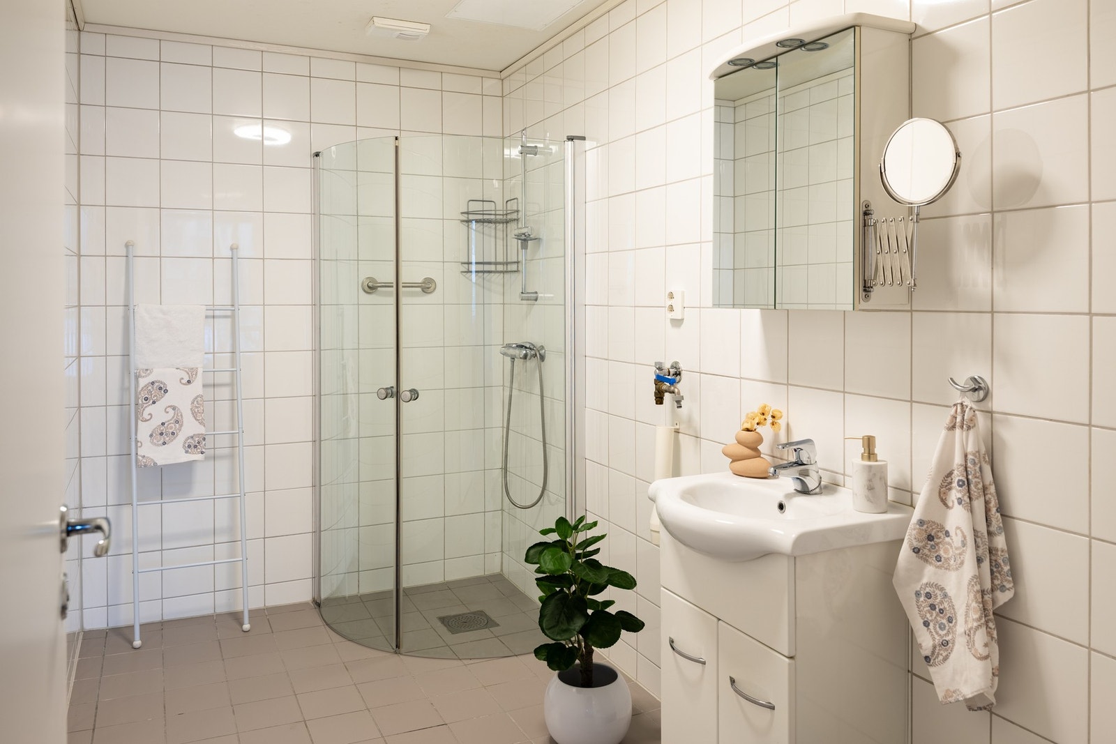 Lyst, flislagt baderom på hele 6,5 kvadratmeter med opplegg til vaskemaskin. Galleribilde