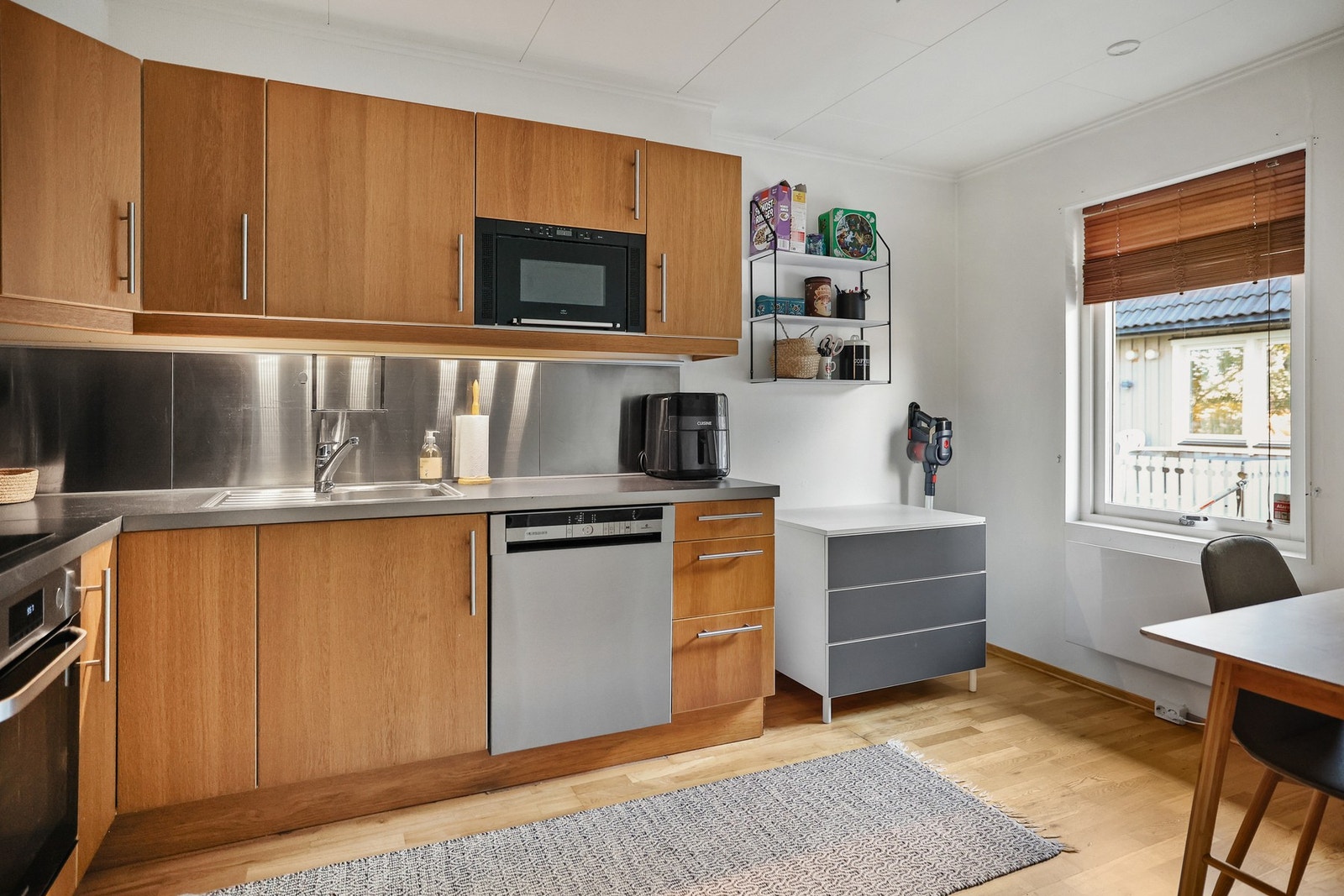 Kjøkkenet har en praktisk utforming med glatte fronter på innredningen, som gir et stilrent preg. Galleribilde