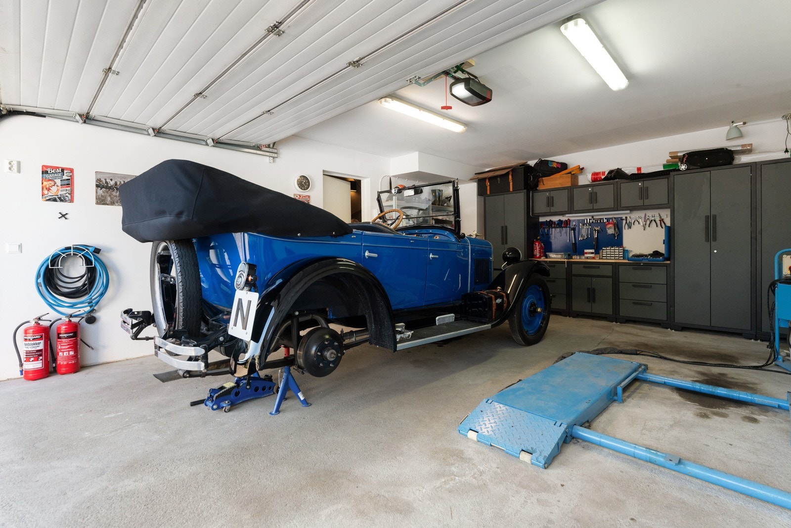 Stor dobbelgarasje med elbil-lader, elektrisk portåpner og godt med lagringsplass i romslig skapløsning. Galleribilde