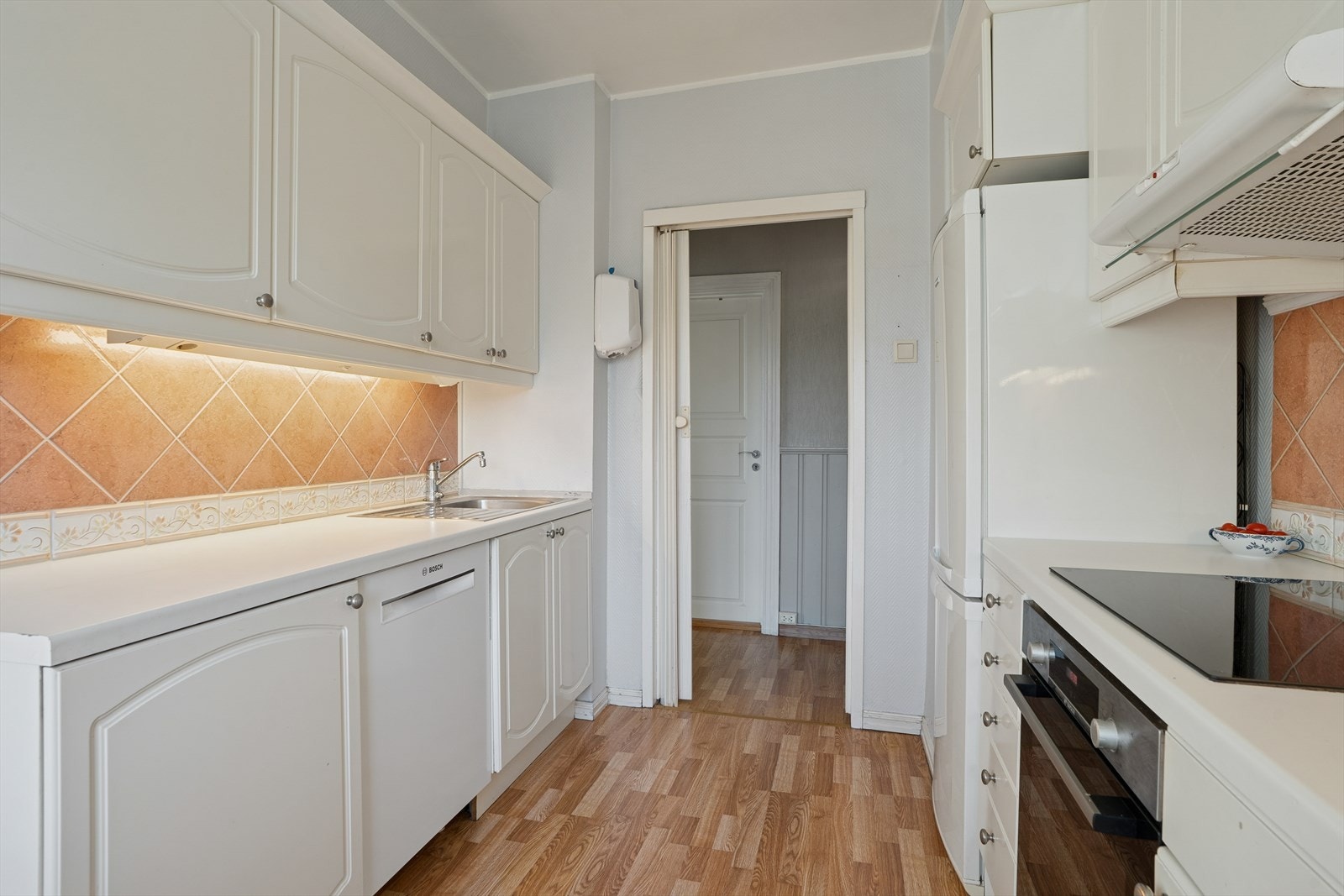 Kjøkkenet består i dag av en hvit profilert innredning med laminat benkeplate. Galleribilde