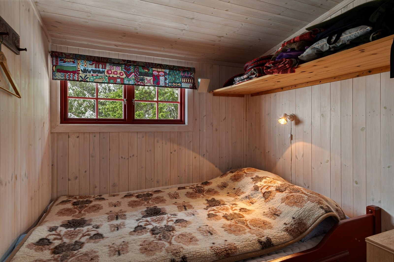 Vindu med rødt rammeverk gir karakter til rommet. Galleribilde