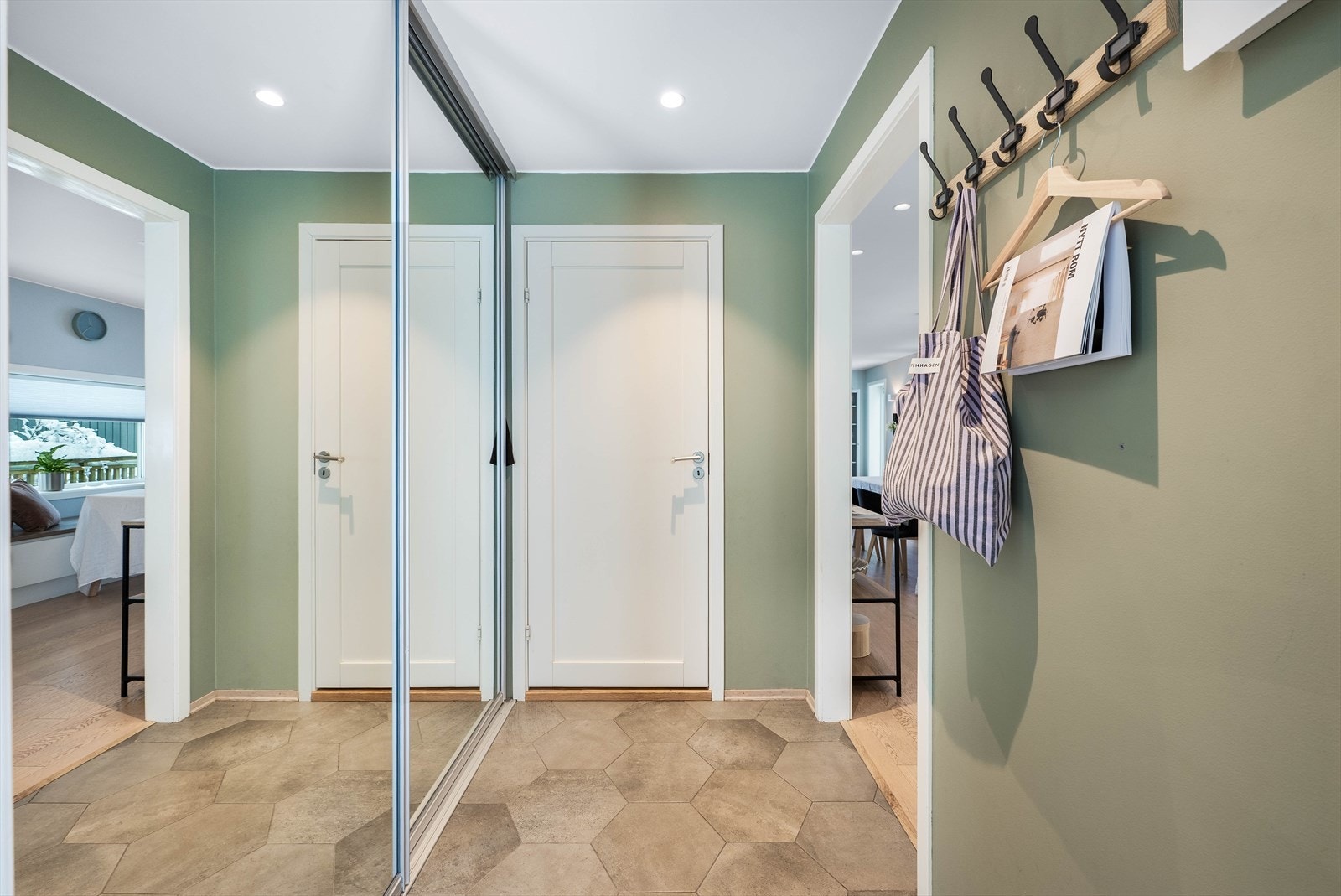 Entreen er innredet med gulvfliser med underliggende vannbåren varme, som sørger for effektiv opptørkning av våte barnesko etter endt dag i barnehagen, eller løpeskoene fra en tur i marka. Entreen er videre innredet med en romslig skyvedørsgarderobe Galleribilde