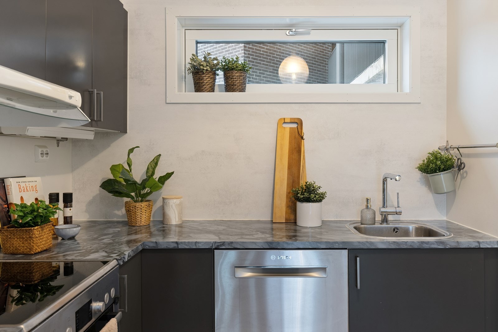 Gjennomført innredning med integrerte hvitevarer og grå, slette fronter - rent, moderne og lett å like. Galleribilde