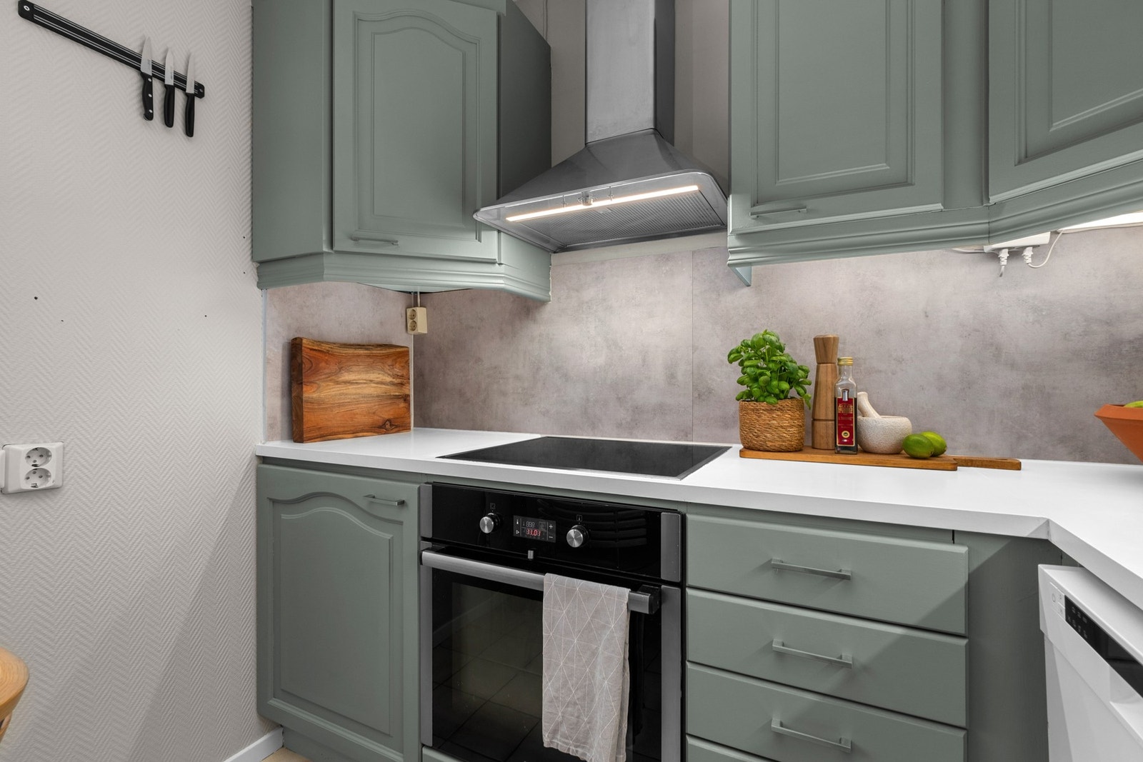 Kjøkkeninnredningen har glatte fronter i malt utførelse med integrert stekeovn Galleribilde