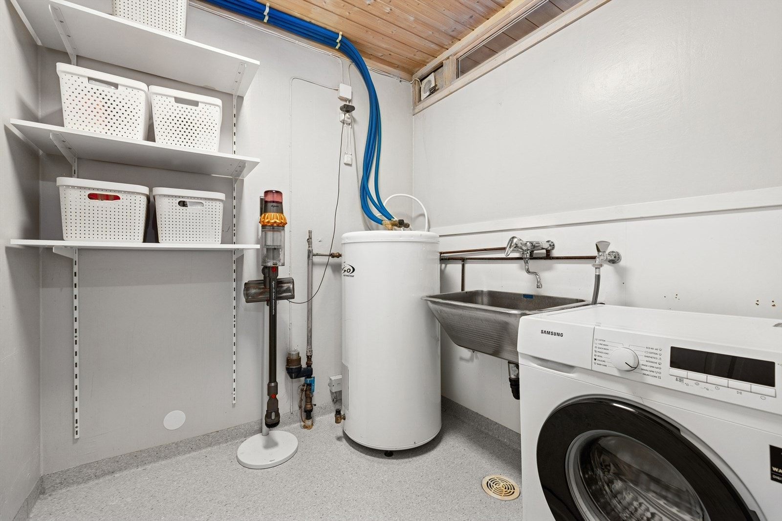 Vaskerom med skyllekar i stål og opplegg for vaskemaskin. Oso bereder i rommet som forøvrig har åpent røropplegg i kobber. Rommet elektrisk styrt vifte. Galleribilde