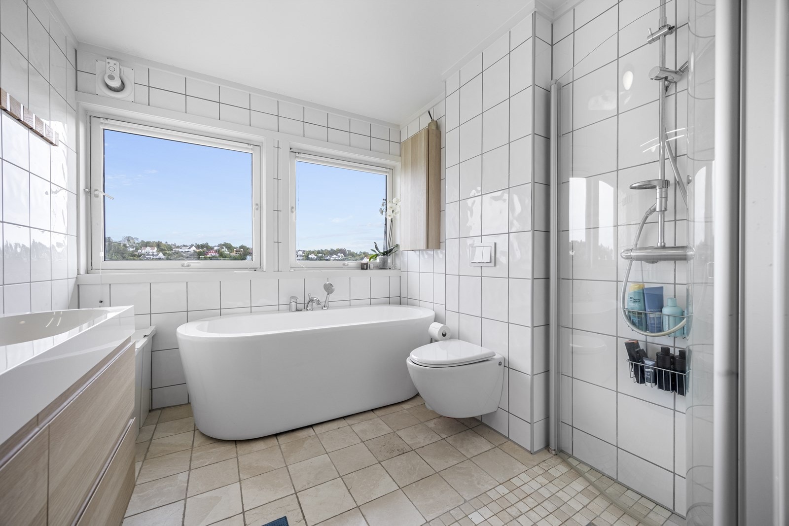 Hovedbadet har vegghengt toalett, dusjhjørne, badekar, dobbel servantinnredning og lintøyskap. Badet har også egen nisje med opplegg for vaskemaskin. Galleribilde