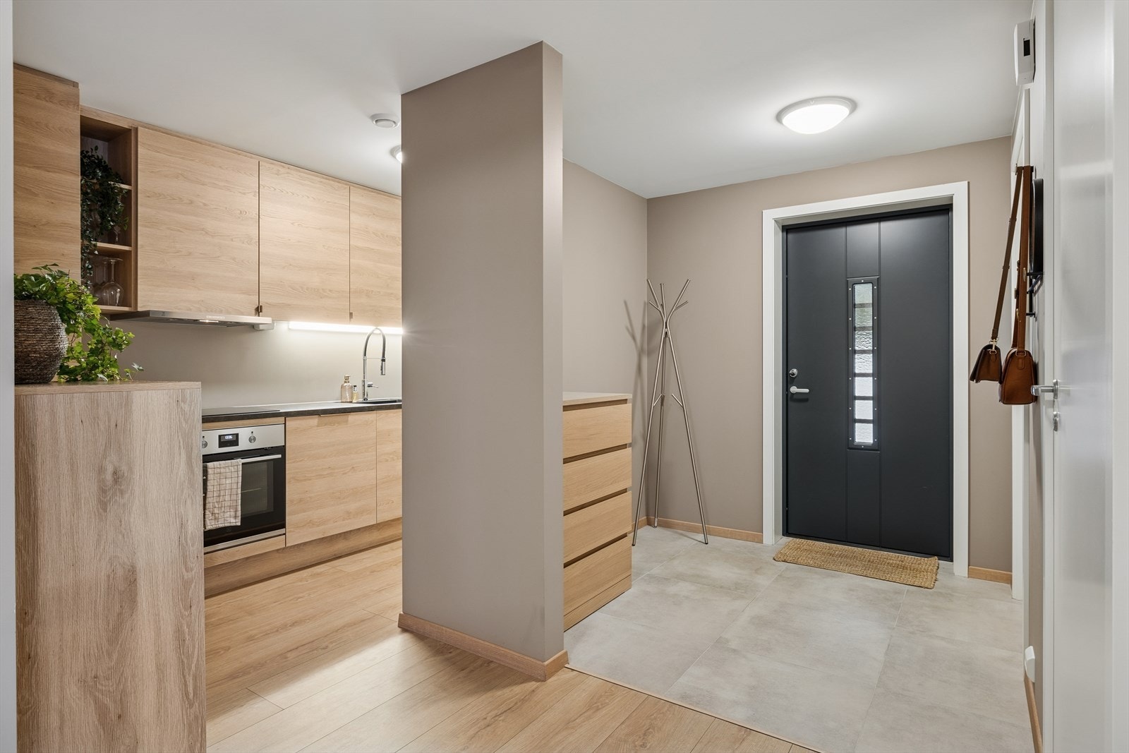 Innbydende entré med flislagt gulv og lysmalte overflater. Galleribilde