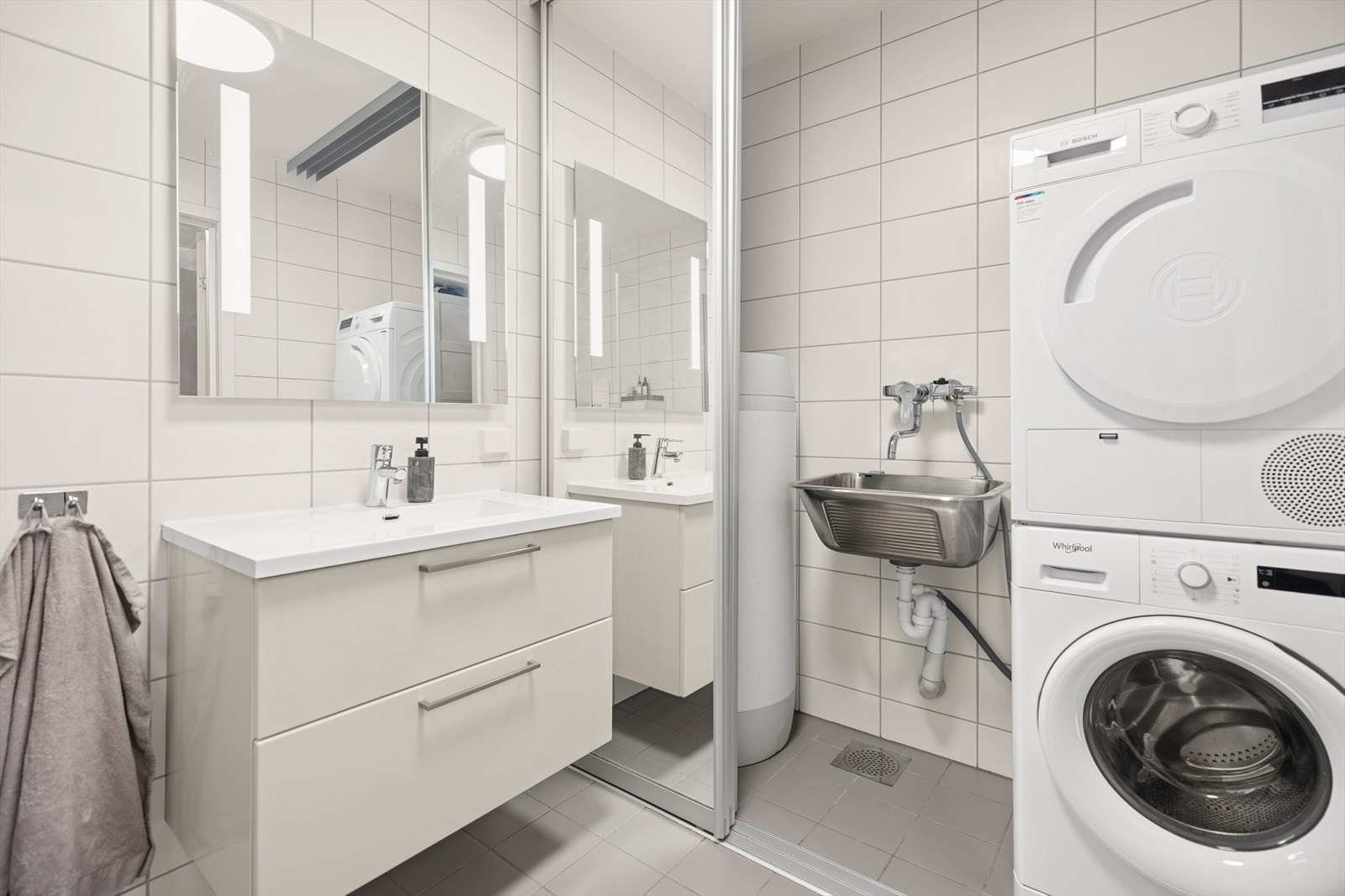 Skyvedører foran varmtvannsbereder, opplegg for vaskemaskin og tørketrommel. Galleribilde