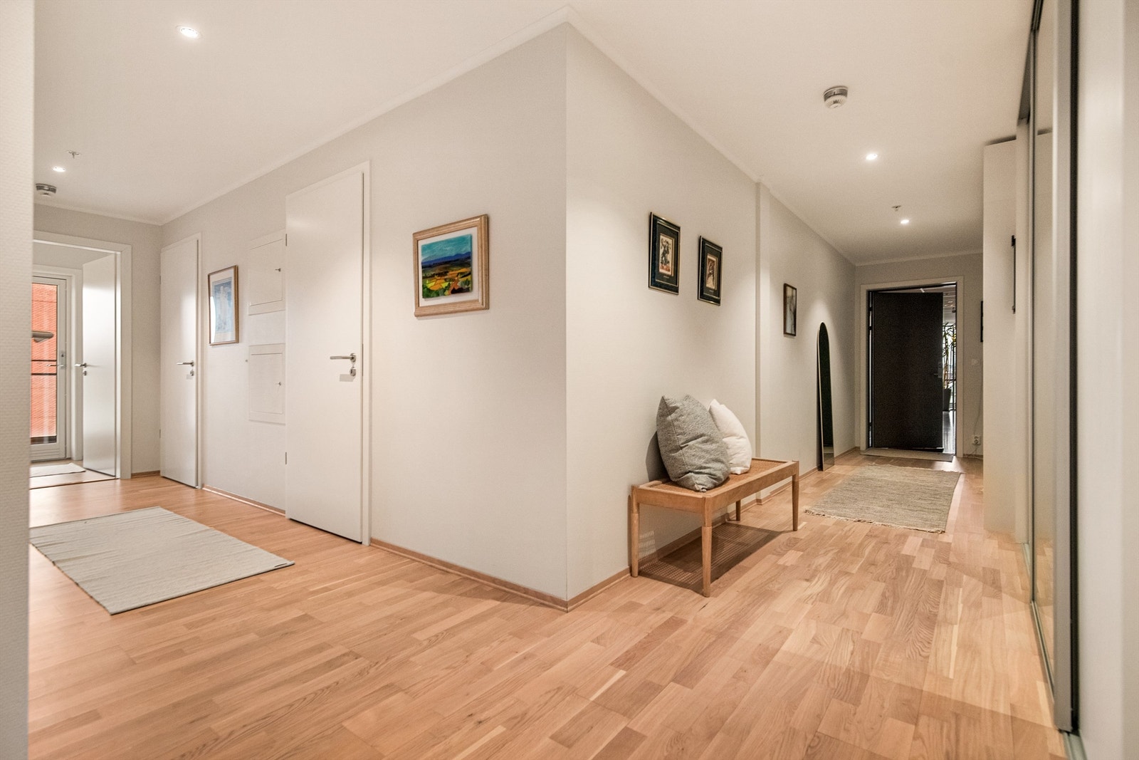 Stor gang/entrè med skyvedørsgarderobe med speilfront. Downlights i tak Galleribilde