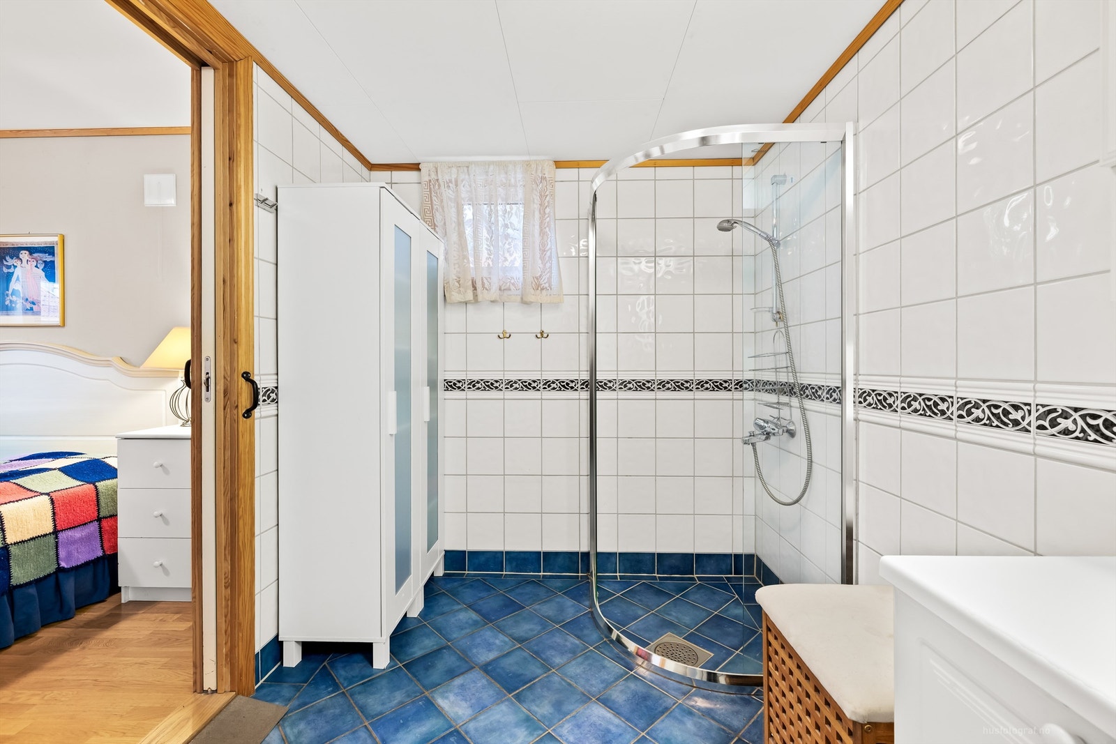 Flislagt bad med dusjhjørne og gulvstående toalett Galleribilde