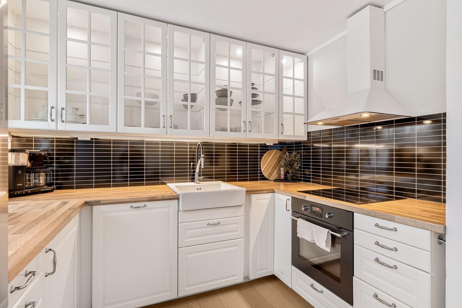 Lys og pen kjøkkeninnredning med profilerte fronter. Integrert ovn og platetopp. Samt oppvaskmaskin., Galleribilde