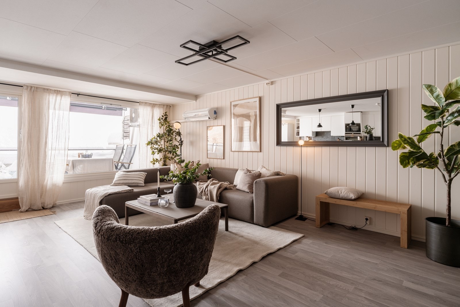 Stuen er lys og luftig med store vindusflater som gir fint naturlig lysinnslipp Galleribilde