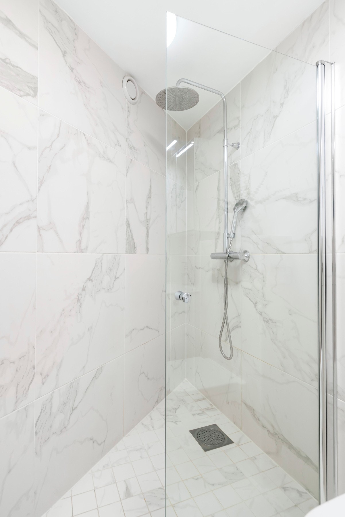 Rommet er innredet med dusjhjørne, veggmontert toalett og servantinnredning. Galleribilde