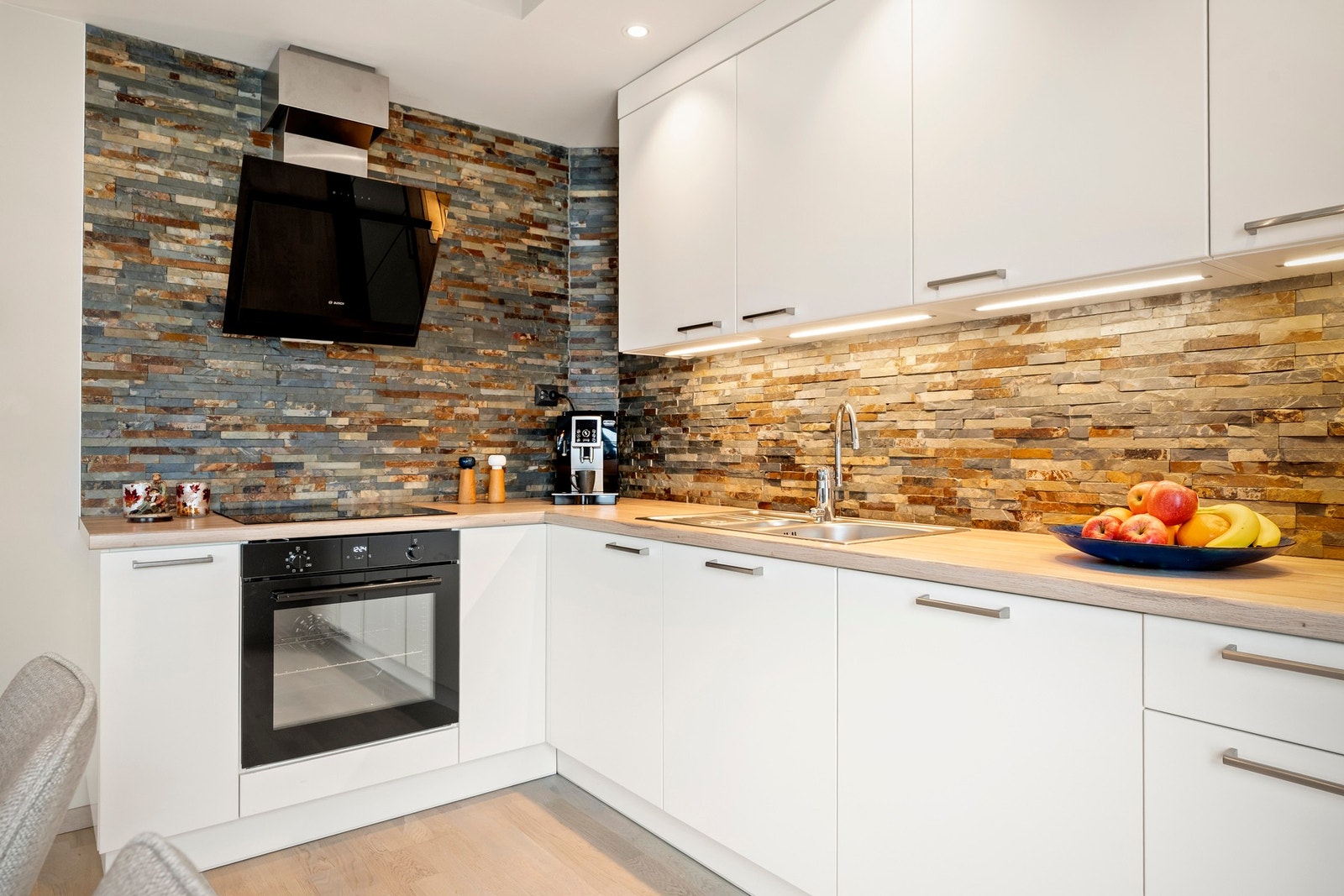 Kjøkkeninnredning med glatte fronter og laminat benkeplater. Galleribilde