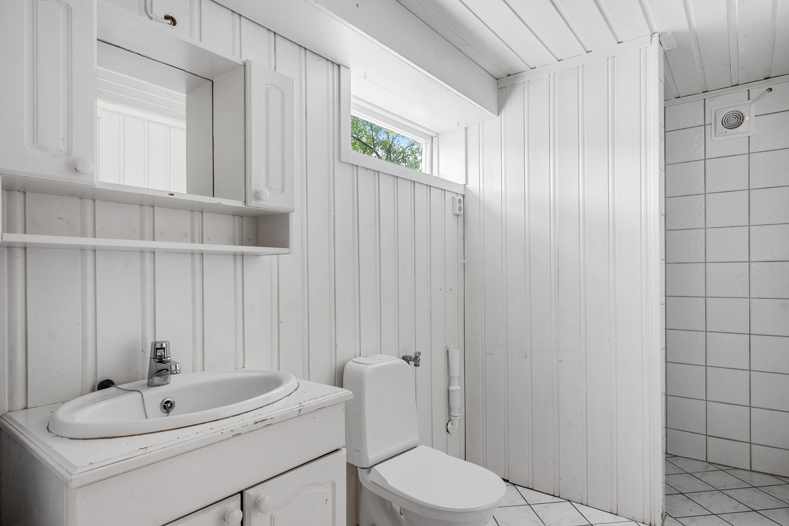 Badet har servantskap, gulvmontert toalett, dusjnisje og røropplegg for vaskemaskin. Galleribilde