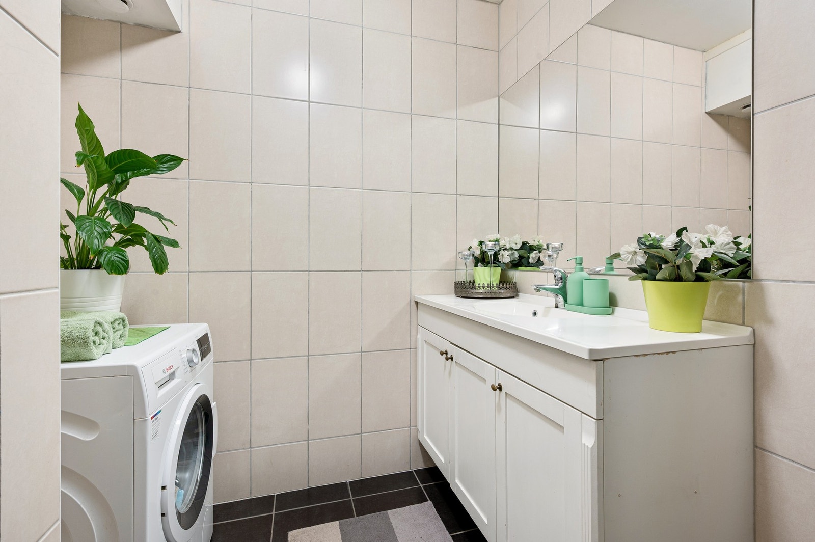 Badet er utstyrt med servantinnredning, opplegg for vaskemaskin og dusjkabinett. Galleribilde