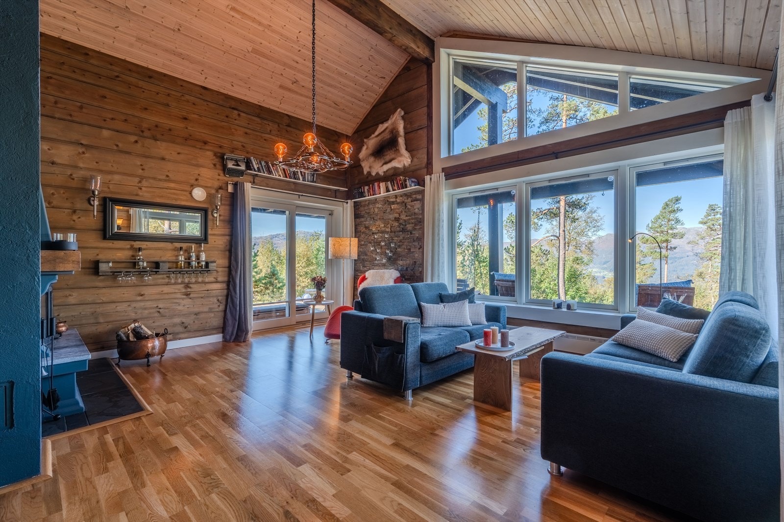 Stue med ekstra takhøyde og store vindusflater som gir godt med lys og utsikt Galleribilde