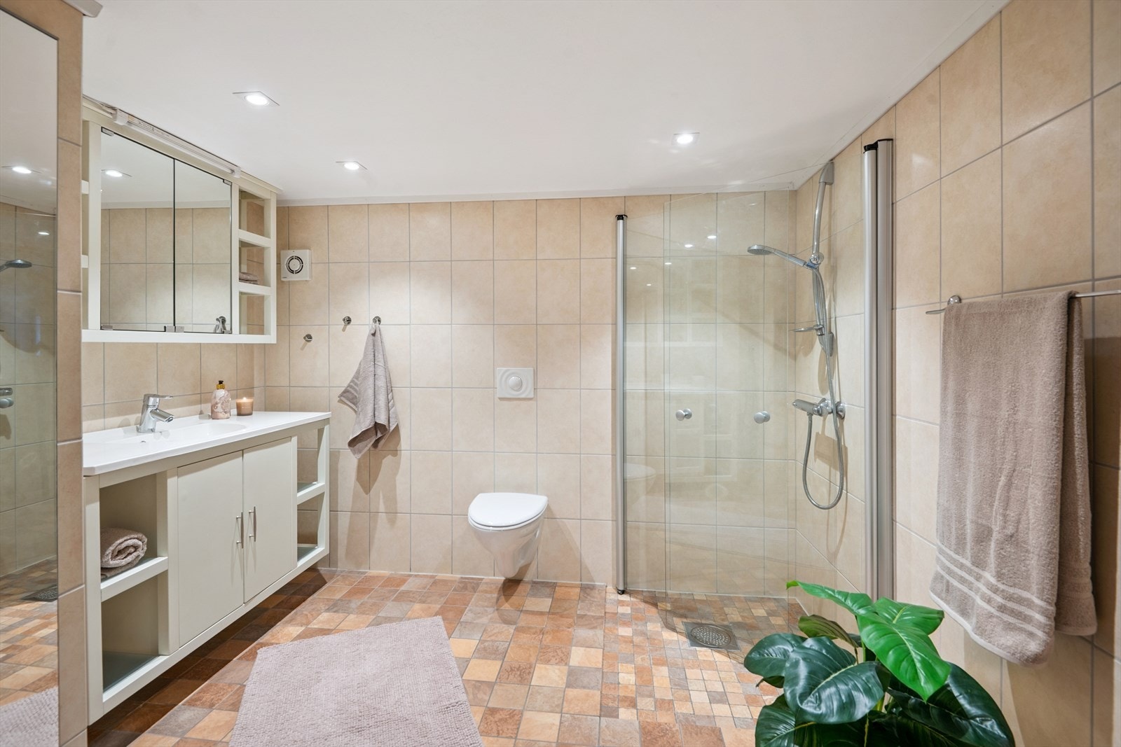 Flislagt bad med elektriske varmekabler i gulv og downlights i himling. Galleribilde