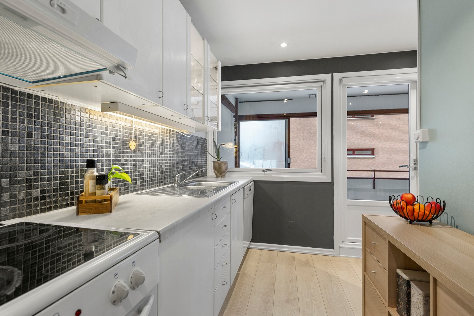 Det er godt utnyttet med hvitevarer som frittstående komfyr, oppvaskmaskin og kjøl/frys Galleribilde