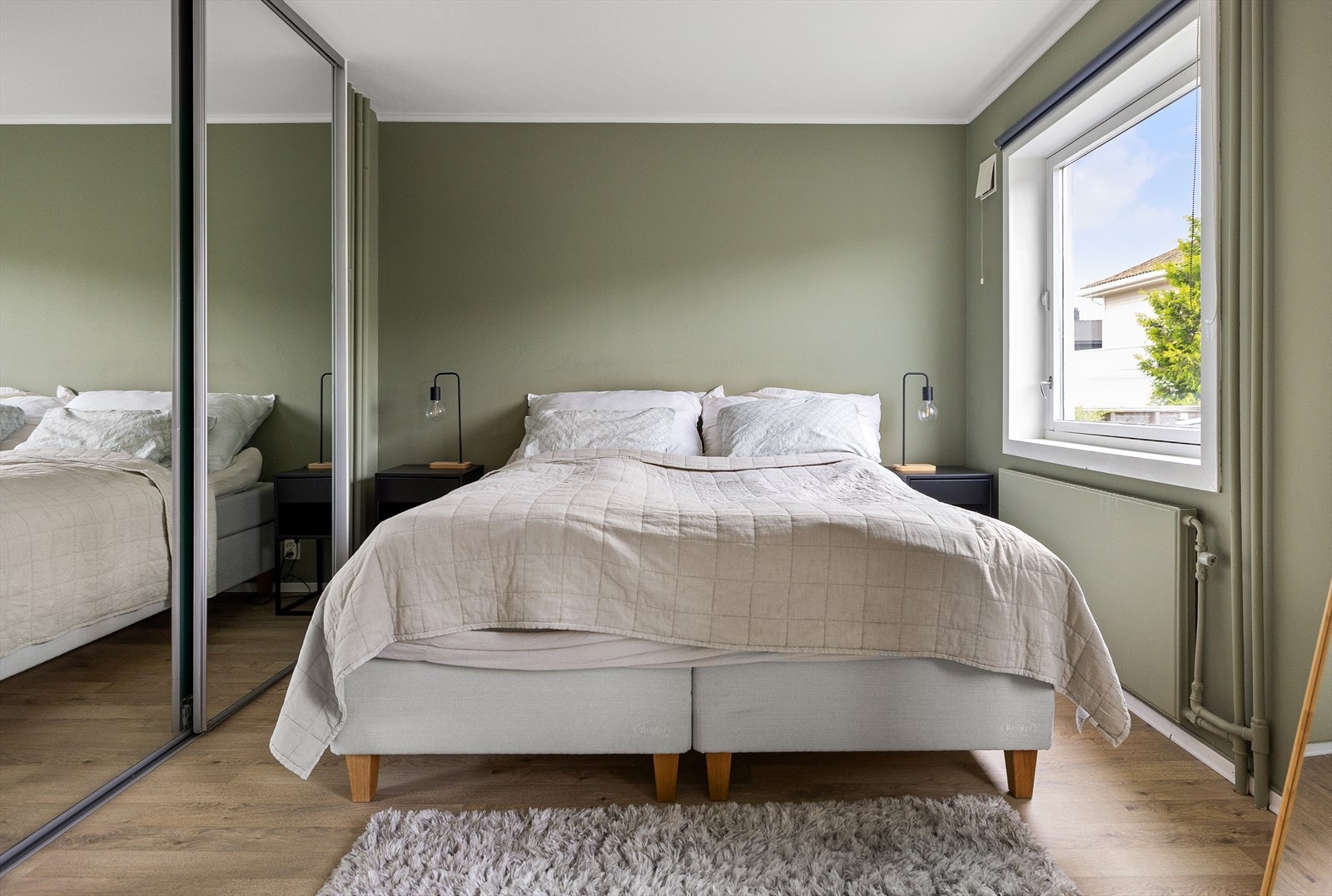 En skyvedørsgarderobe strekker seg over hele soverommets ene vegg. Galleribilde