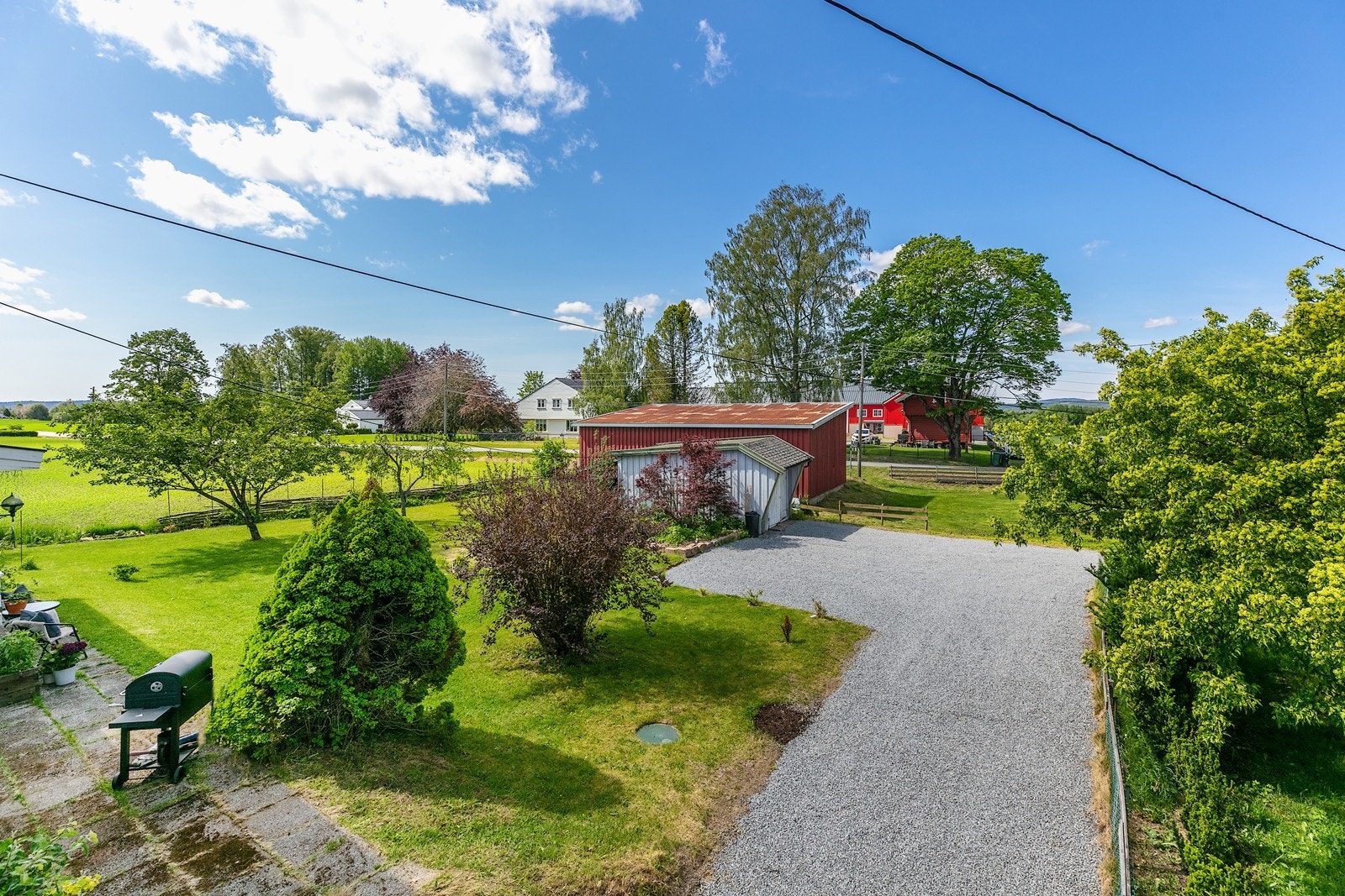 Sommerbilde:
Boligen er omgitt av frodige grøntområder og har en velholdt plen og gruset innkjørsel. Galleribilde