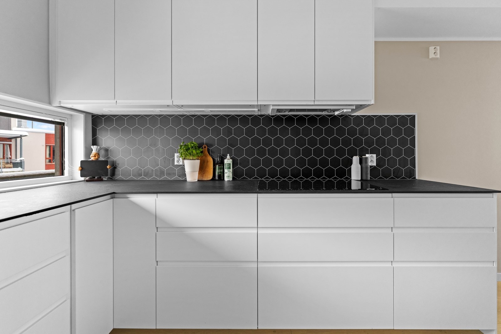 Innredningen ble montert i 2021, med hvite glatte fronter, sort benkeplate og nedfelt oppvaskkum. Galleribilde