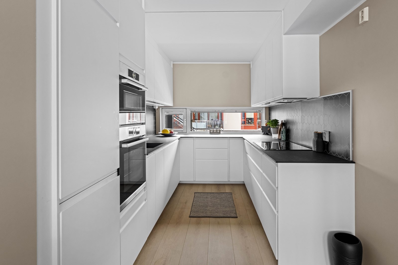 Kjøkkenet er stilrent og moderne, oppført i en smart u-form med mye skap- og benkeplass. Galleribilde