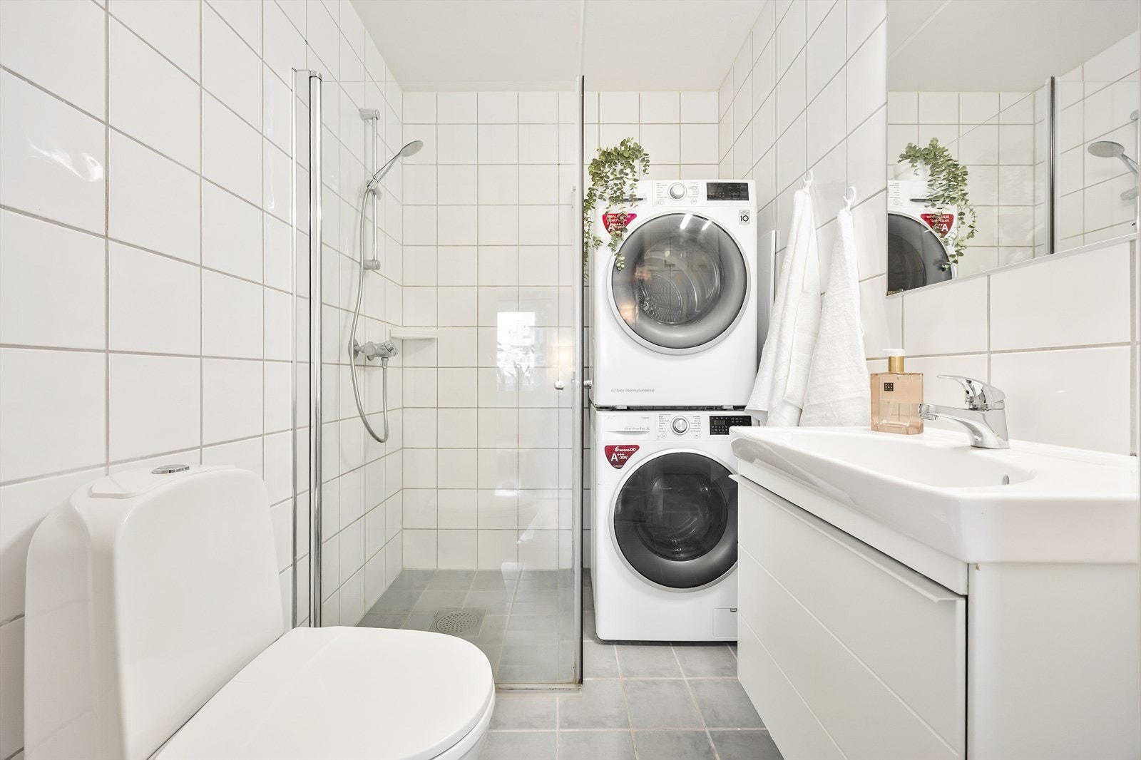 Badet er flislagt med varme i gulvet og opplegg for vaskemaskin. Galleribilde