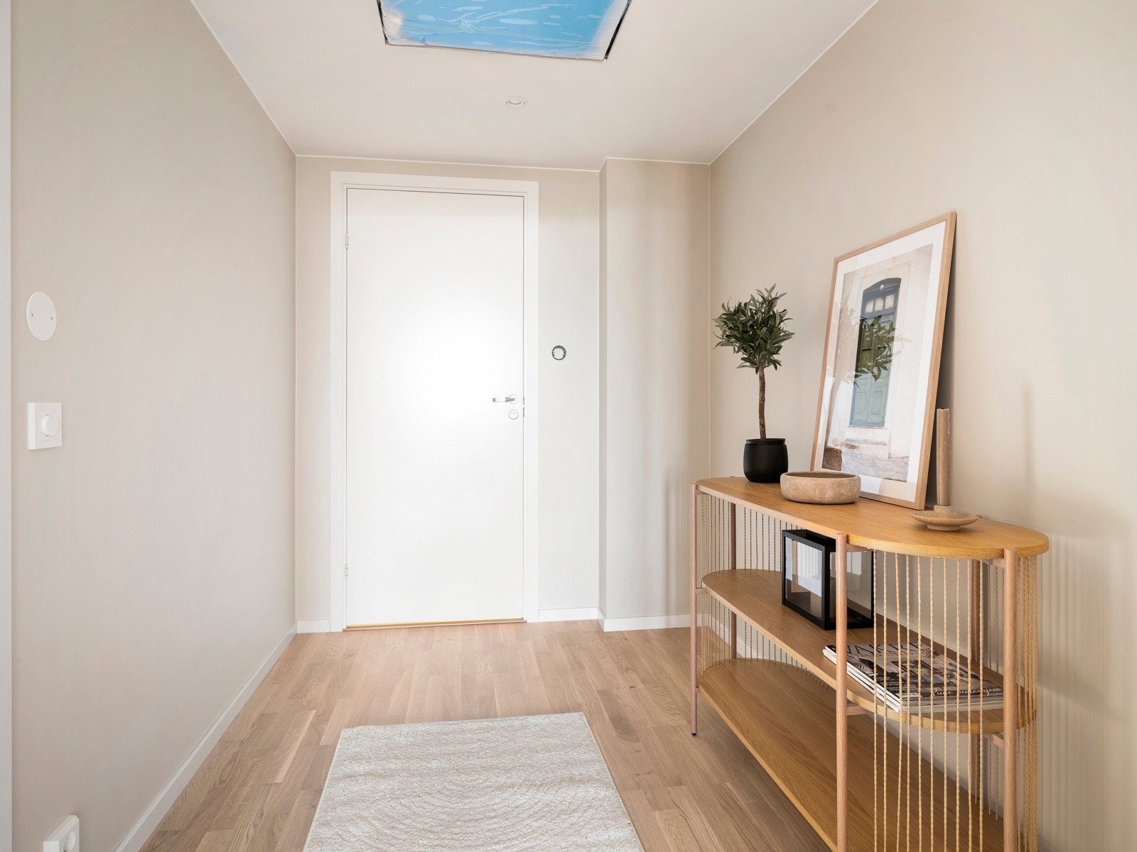 Lys og tiltalende entré med vegger malt i den tidsriktige fargetonen NCS 1704-Y19R Space. Lys hvitpigmentert eikeparkett og vannbåren gulvvarme gir et lyst, moderne og komfortabelt førsteinntrykk av leiligheten. Galleribilde