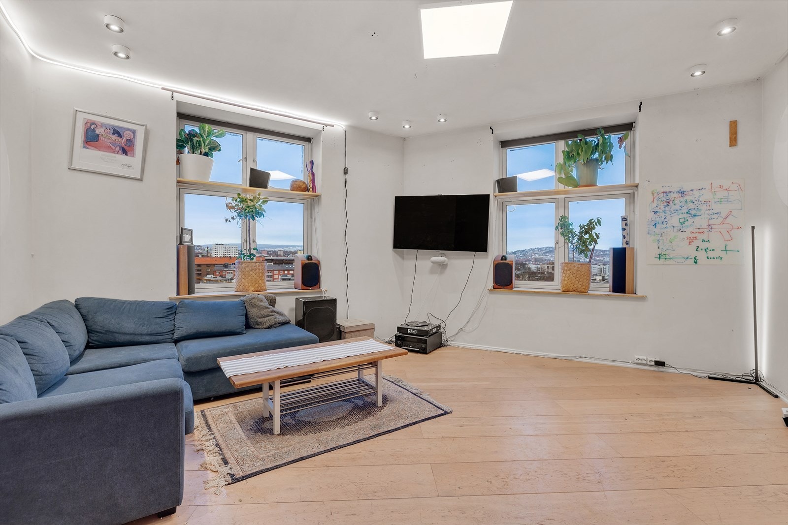 Lys og innbydende stue med plass til en stor sofagruppe og annet møblement. Galleribilde