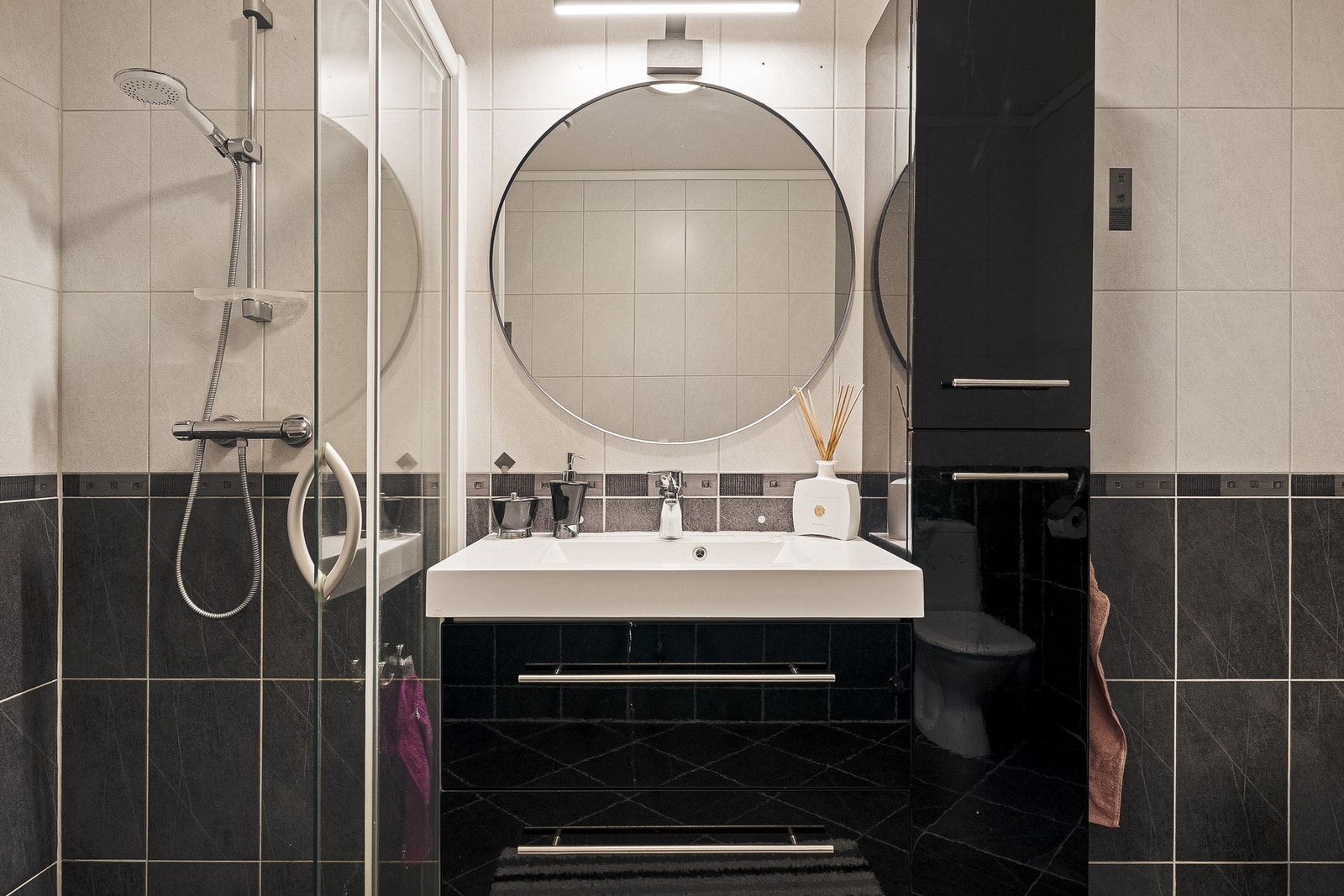 - Badet er utstyrt med toalett, dusjhjørne og servant med stort møblement - Galleribilde