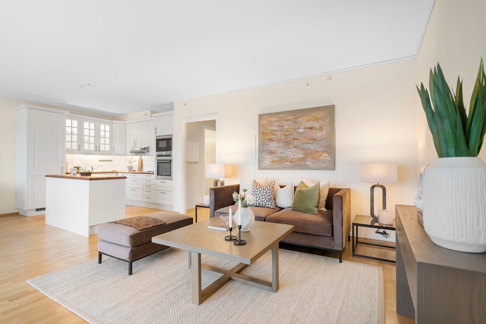 Kort avstand mellom stue og kjøkken skaper et sosialt og samlende oppholdsrom Galleribilde