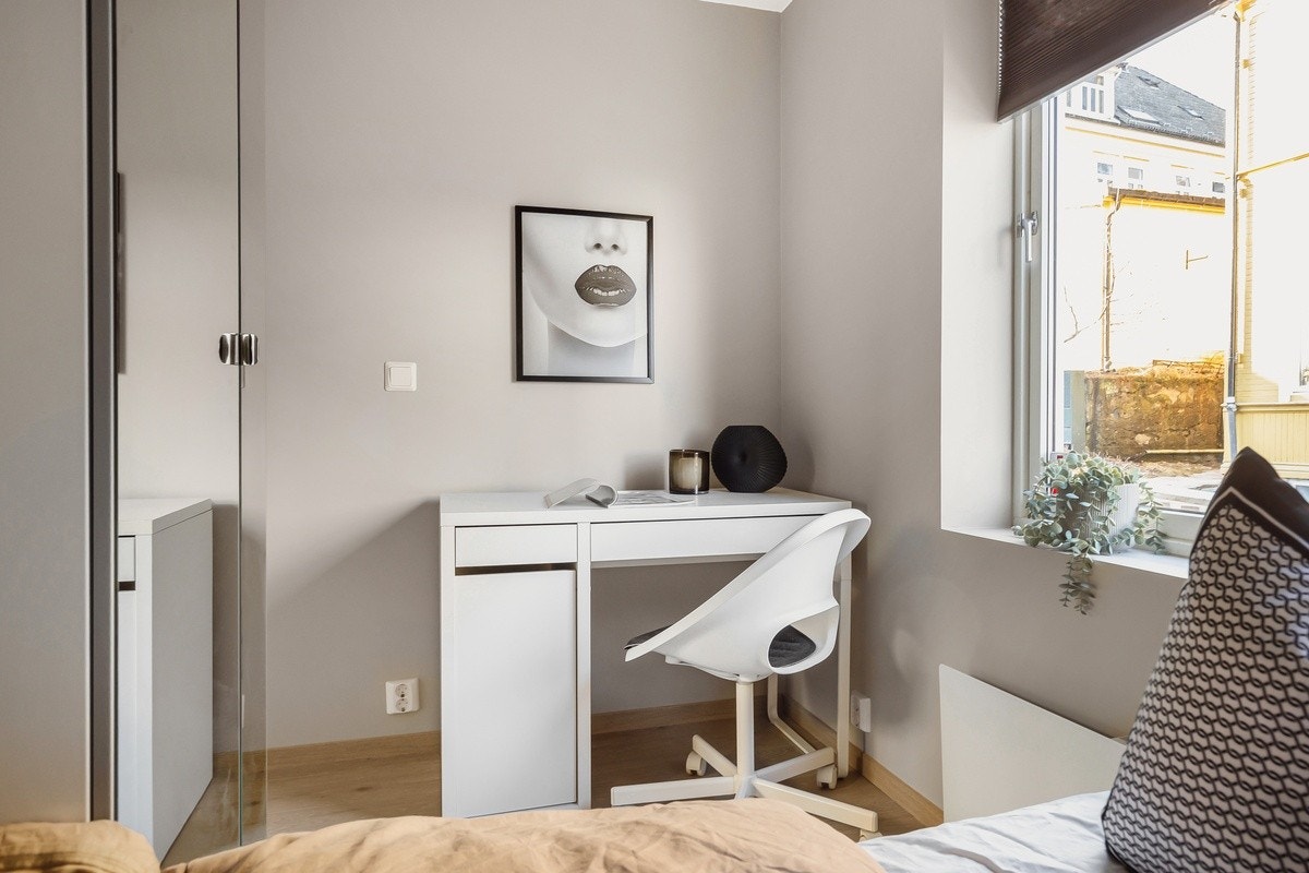 Råstilige soverom som er innredet med garderobeskap, seng, pult, stol, panelovn og plisségardin. Dette er Mars. Galleribilde