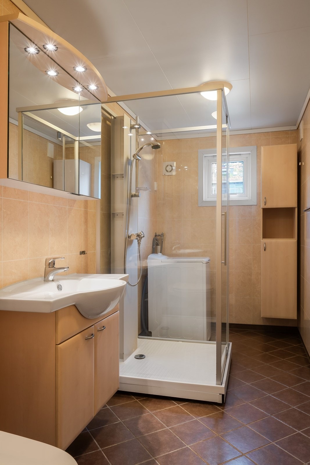 Badet ble renovert og utvidet ca. 2010-2015. Flislagt gulv med varmekabler, baderomsplater på vegger og takplater i himling. Servant med møblement, speilskap med belysning, høyskap, vegghengt toalett, dusjkabinett og opplegg for vaskemaskin. Galleribilde