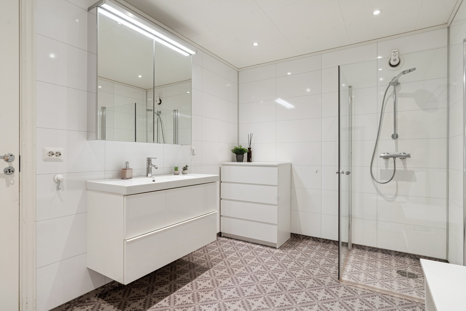 Underetasjen har bad (renovert i 2015). Belegg på gulv og våtromsplater på vegger. Belegg fra 2015 og det er ikke kjent om sluk ble byttet i denne forbindelse eller om den er fra byggeåret. Galleribilde