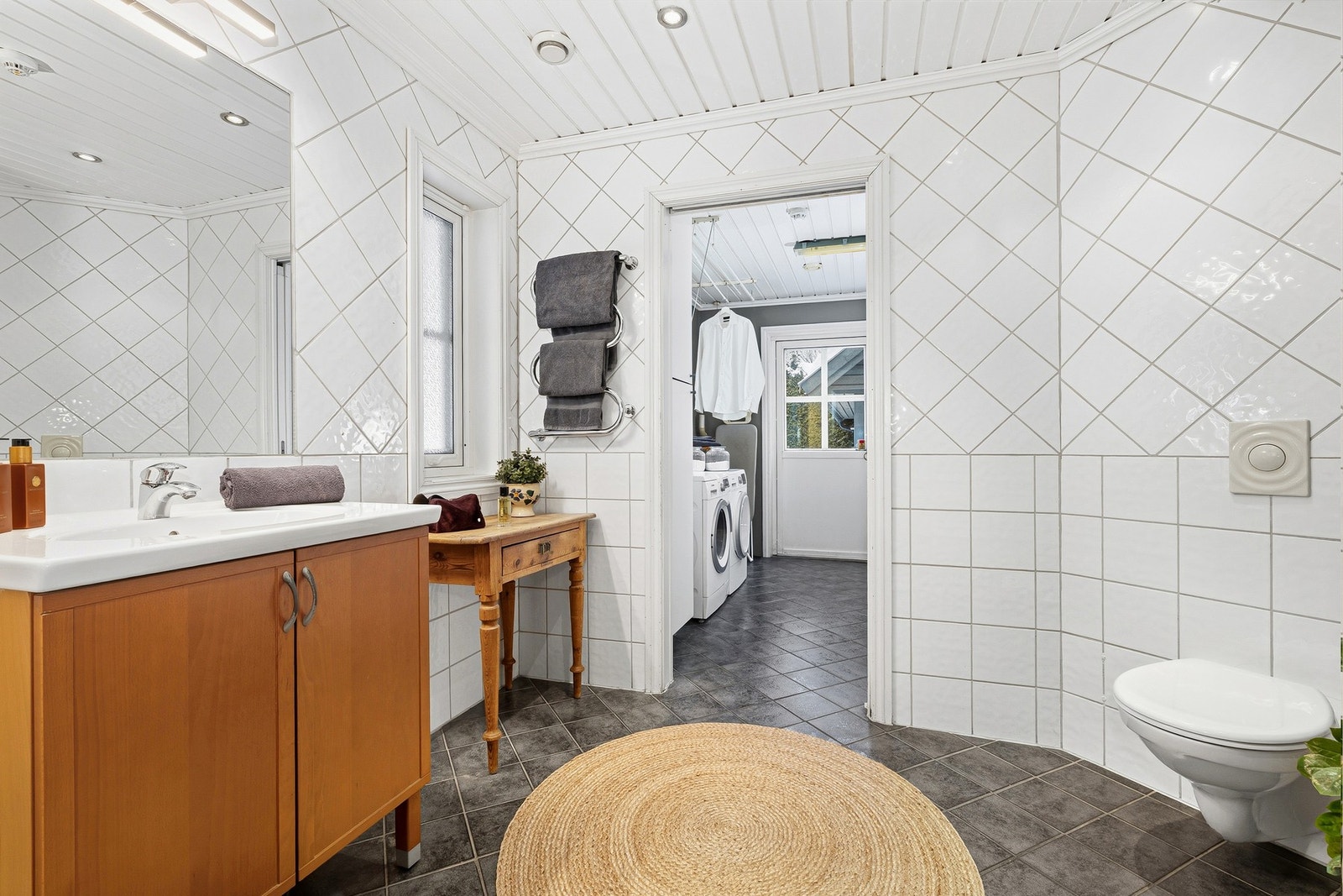 Det romslige badet har direkte tilgang til et vaskerom med utgang til terreng. Galleribilde